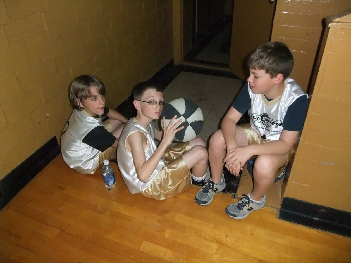 Image: The boys await — Levi, Ty and Thomas relax before their game.