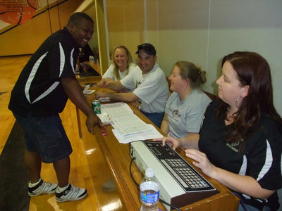Image: The Commissioner’s crew — IYAA Basketball Commissioner Glen McClendon checks on his “peeps” before the game.