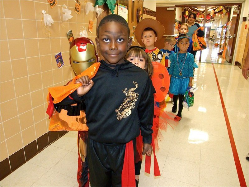 Image: Ready for Halloween — John Hall leads his fellow Halloween trick-or-treaters down the hall of course.