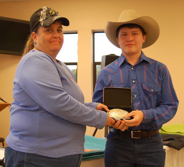 Image: Jake Escamilla — ECEA Vice President Becky Hansen presents Jake Escamilla with the Champion Mares at Halter buckle.