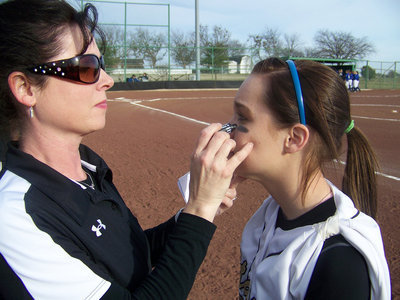 Image: War Paint — Assistant Coach Andi Windham applies eyeblack to “Drew-nella”