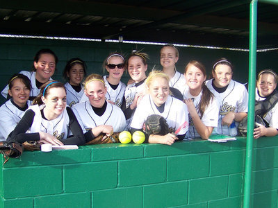 Image: Group Shot — The “Ladies” get together in the dugout for a quick photo opp.