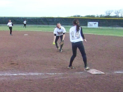 Image: Catch and Throw — Cori Jeffords fields the ball and tosses to Drew Windham at first base for an out.