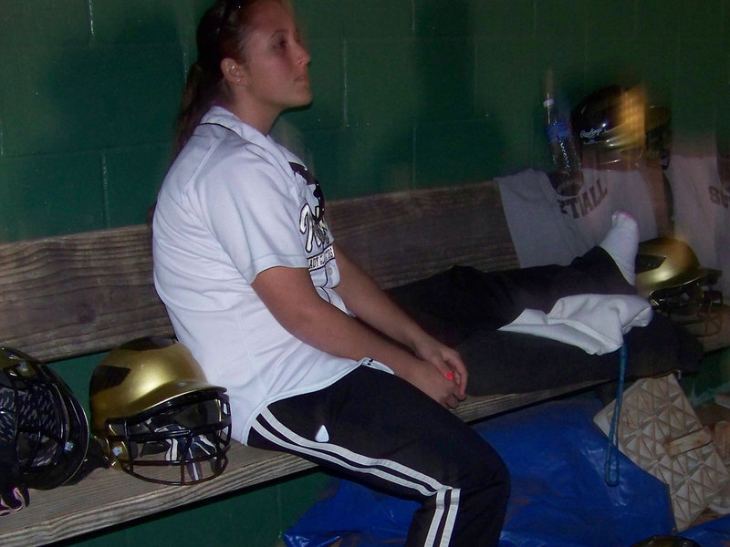 Image: Senior Angelica Garza — Injured center fielder, “Jelly”, watches from the dugout.