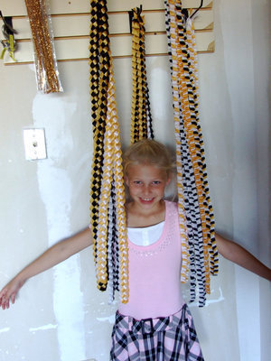 Image: Taylor Boyd wearing braids — Taylor is showing you the braids you can choose for your mum.
