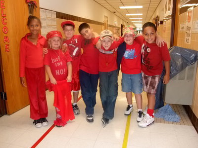 Image: Dressed in Red — Destiny Harris, Haylee Mathers, Gage Wafer, Andrew Celis, Ty Beets, Noah Johnson, CC Cornelius are all in the spirit of “Red Out Drugs” day.