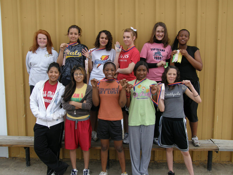 Image: 8th Grade Girls — The 8th Grade Girls 2009 Track Team is loving every minute of it as they show-off their winnings from the Dallas Gateway track meet.