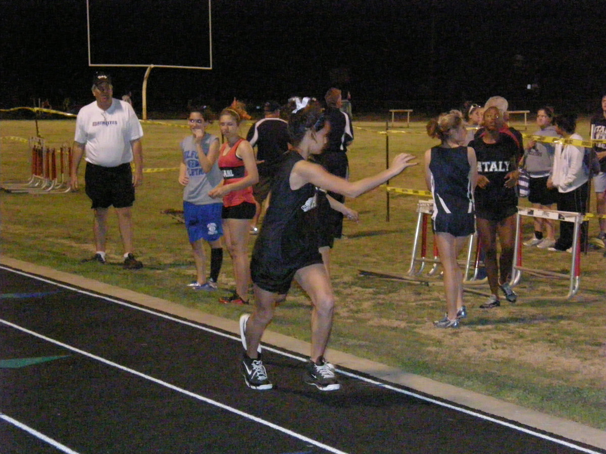 Image: Anna takes baton — Anna Viers takes the baton during the Panther Relays in Maypearl.