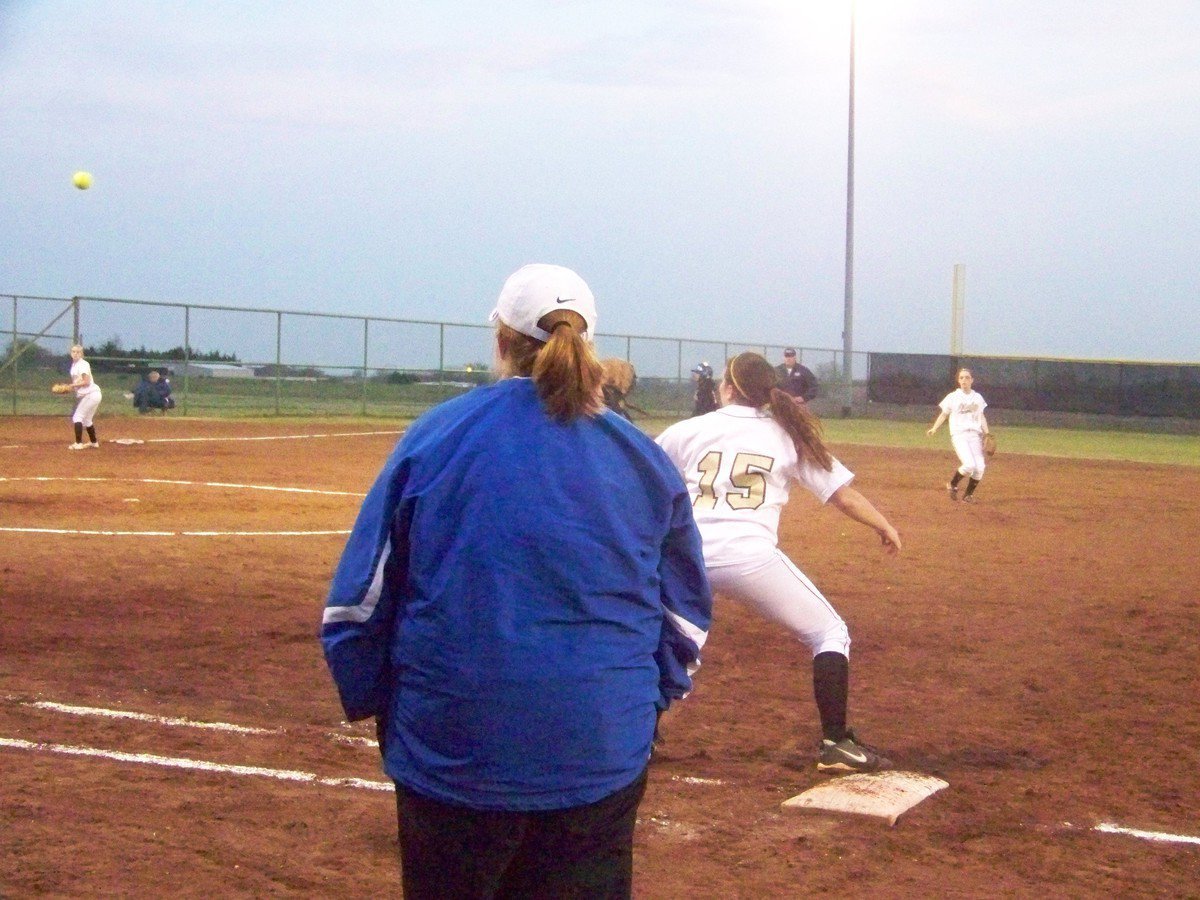 Image: Make the stretch Cori! — Cori Jeffords (Junior), at first base, makes the stretch towards the throw.