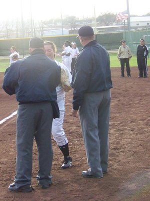 Image: Nikki Brashear — Nikki shakes the hands of the officials before taking her position in the outfield.