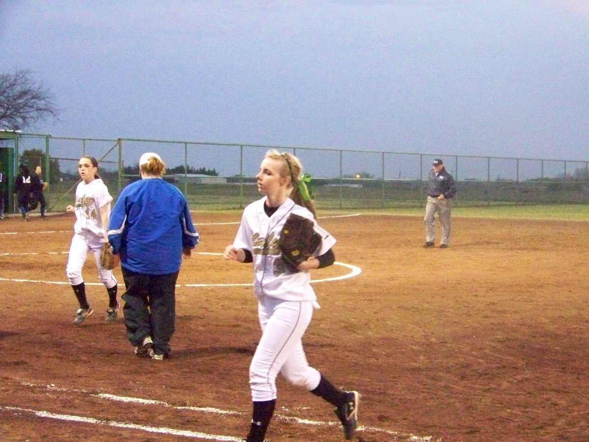 Image: Three Down! — The Lady Gladiators come off the field after putting an end to Rice’s turn at bat.