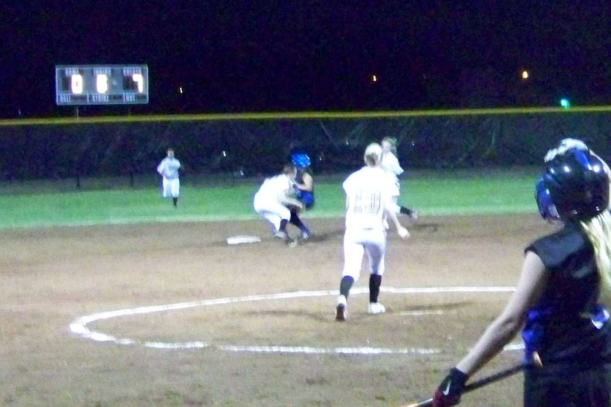 Image: Collision — Drew Windham (short stop) takes in a throw by catcher, Julia McDaniel, and tags the runner out that attempts to steal second base.