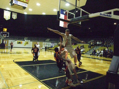 Image: No Net — Kyle Wilkins acrobatically defends the paint working without a net.