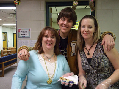 Image: Lets Eat Cake — Pam Luttrull, Tyler Boyd and Kristi Dollar all helping with the Mardi Gras.