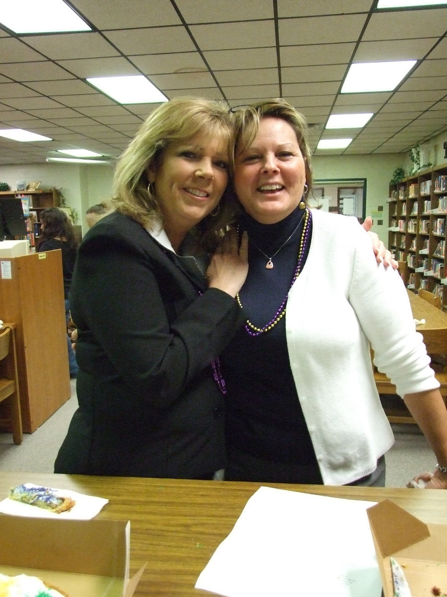 Image: Say Cheese! — Substitute teacher Celeste Carroll and school counselor Cari Cochran are enjoying Mardi Gras in the library.