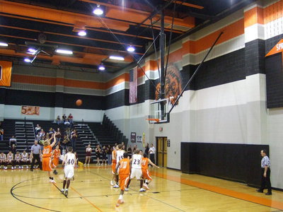 Image: Knight Shoots — #22 Jeremy Knight takes an open shot at the free-throw line.