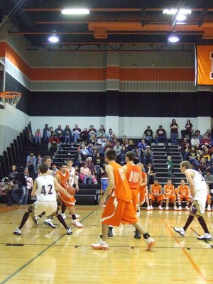 Image: 
    	Romero — Andrew Romero (Sr.) takes the ball in the paint trying to get a shot off.
    