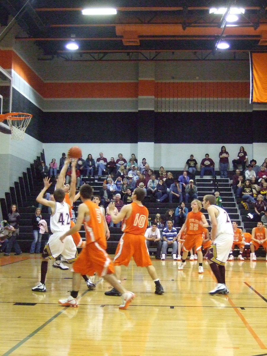 Image: Romero Jumps — #11 Romero rises above everyone to grab the rebound.