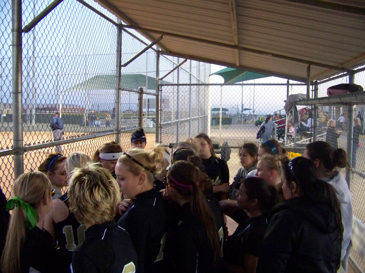 Image: Pre-game talk — Coach Reeves rallies her players before the game.