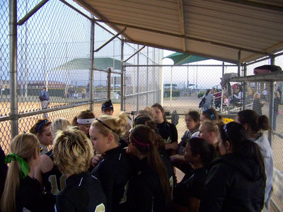 Image: Pre-game talk — Coach Reeves rallies her players before the game.