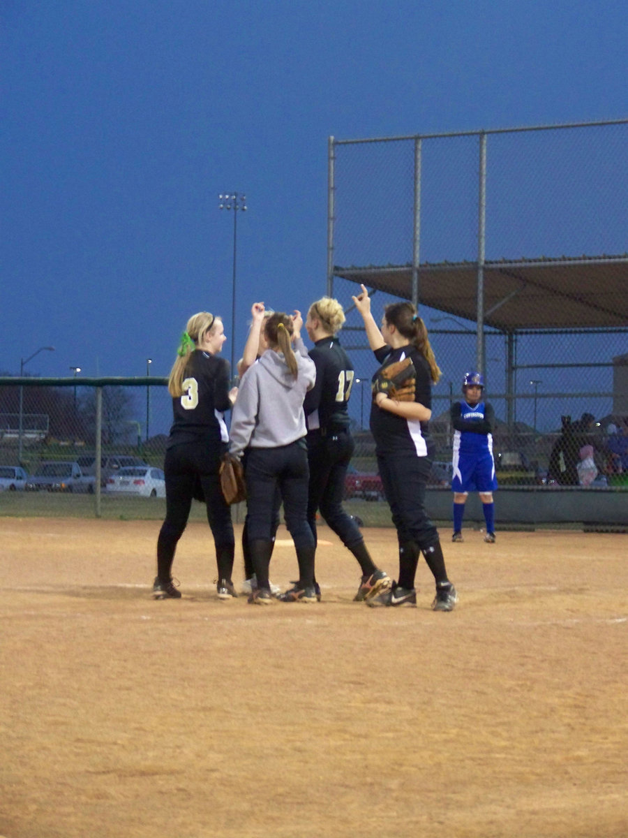 Image: Congratulations! — Team mates congratulate Freshman pitcher Megan Richards after her first strikeout (first batter) of her High School softball career.