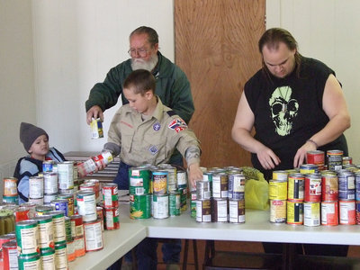 Image: Separating cans — Separating the food is just one of the jobs Pack 227 helps with.