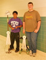 Image: Cruz Enriquez and Zac Mercer get ‘eco’ creative — Cruz Enriquez displays his Welded Floor Lamp and Zac Mercer displays his Mountain Dew® Table. Enriquez received 3rd Place in the 14-18 year old division and Mercer was awarded 3rd Place in the 9-13 year old division during Austin Rodeo’s ‘Eco Art Show.’