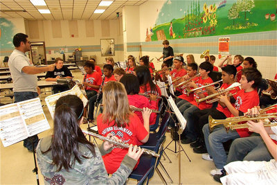Image: Powerful music — Jesus Perez conducts the newly formed Stafford Elementary 6th grade Roaring Tigers Band in an uplifting rendition of ‘Power Rock’ to help inspire the 5th grade TAKS test takers.