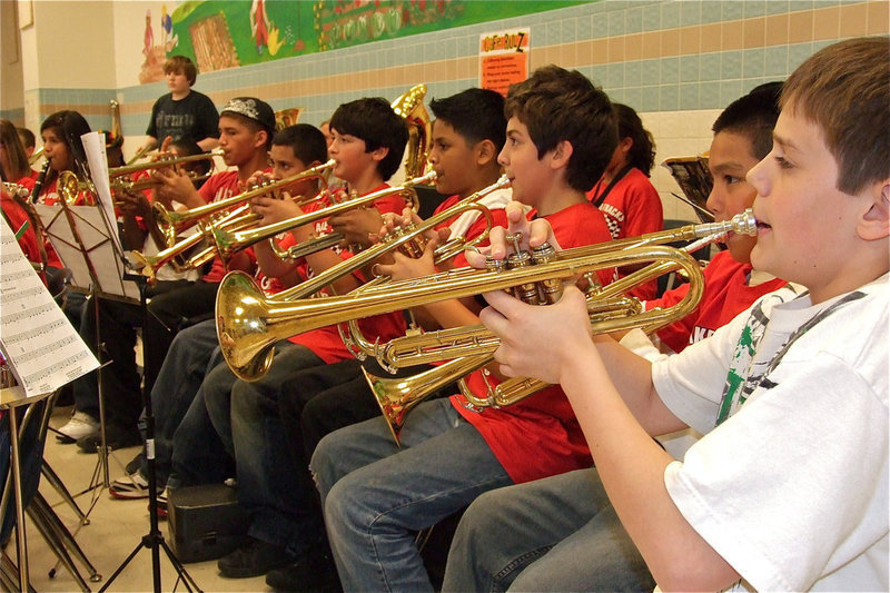 Image: Loud and proud — The 6th Grade band’s trumpeters blare encouragement on behalf of the 5th grade class.