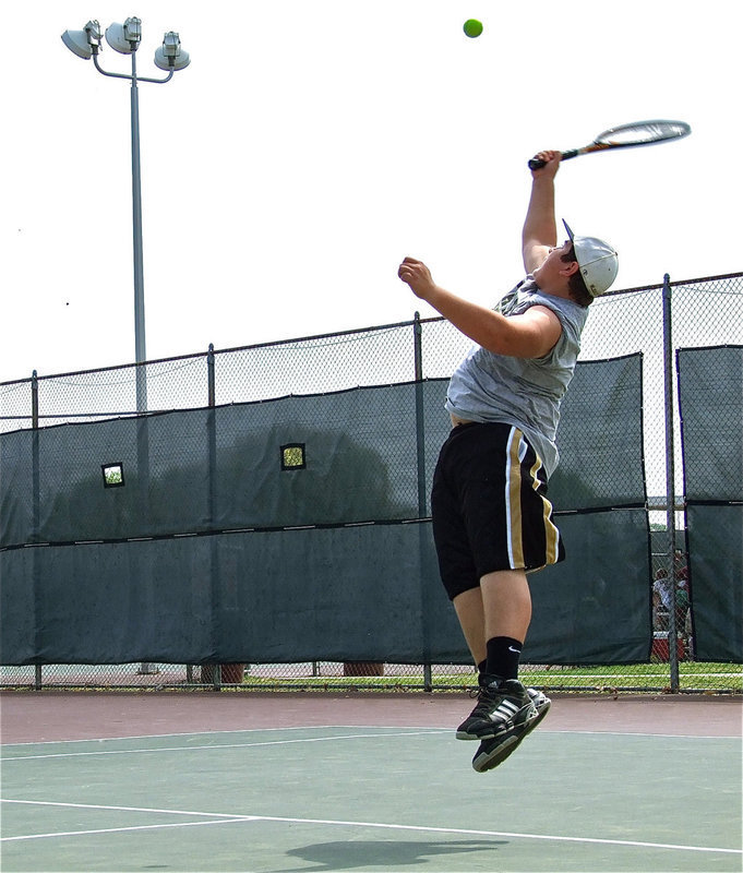 Image: Kevin Roldan leaps high to return the volley — Italy’s Kevin Roldan elevates his level of play during the Rice Invitational tennis meet held at the Mertz Tennis Park in Corsicana on Saturday. Italy used the event to better prepare for the upcoming district meet.