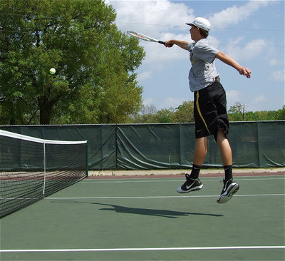 Image: Optical illusion? — Cole Hopkins, all 6’6" of him, makes the tennis court seem like a miniature model as he dominates the net.