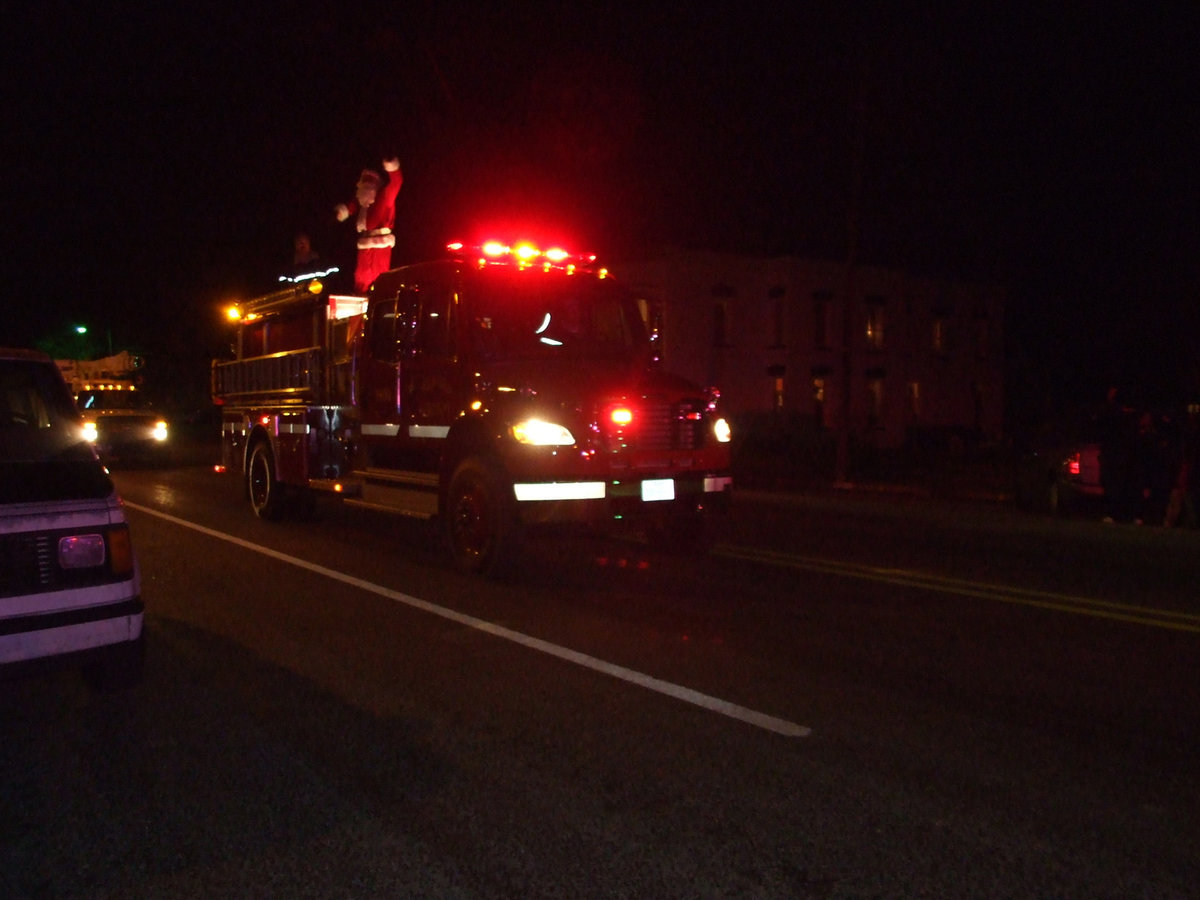 Image: Where is Santa’s sleigh? — Santa arrives on top of a fire engine instead of a sleigh.