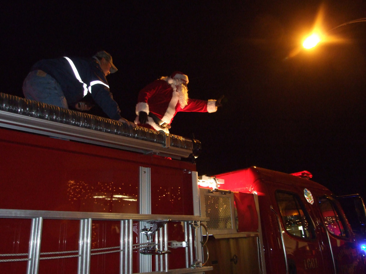 Image: Let’s meet Santa — Santa waves to the excited children.