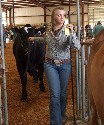 Image: Another ribbon — Jacqualyn Crowley gets breed champion and reserve breed champion in the Beefmaster heifer class.