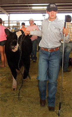Image: Clayton leads way — Clayton Campbell is awarded 1st in class with his animal.