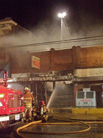 Image: Milford Cash Grocery destroyed by fire — Local firefighters manage to douse the flames from inside the Milford Cash Grocery building and spare adjacent structures Tuesday night and into Wednesday morning.