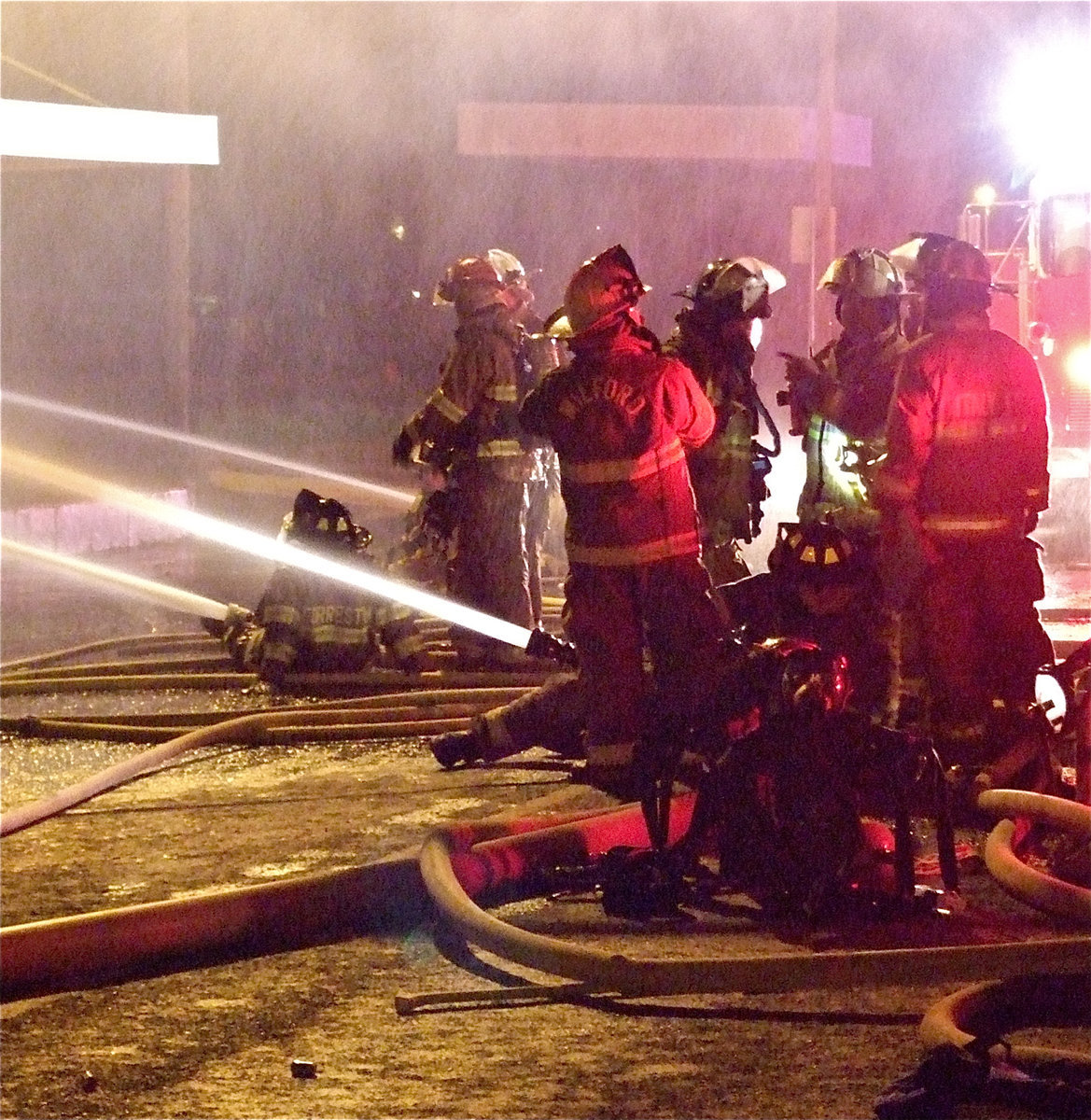 Image: Battling the blaze — Fire crews attack the front of Milford Cash Grocery with multiple streams of water.