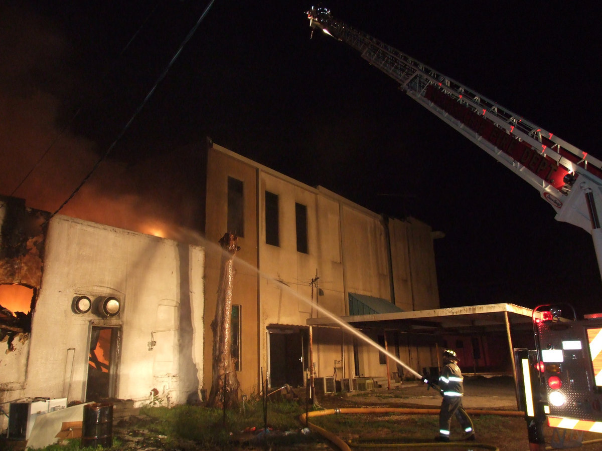 Image: Up in smoke — Waxahachie’s Ladder 3 engine extends its ladder to attack the fire from high above.