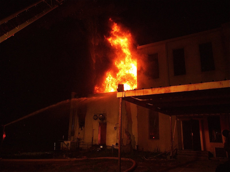 Image: Fire rages on — Fire crews deal with the flames from the backside of Milford Cash Grocery.