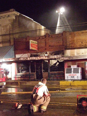 Image: Exhausted — Milford Cash Grocery was destroyed by fire Tuesday night but four local engine companies and 37 fire fighters were able to spare the surrounding buildings.