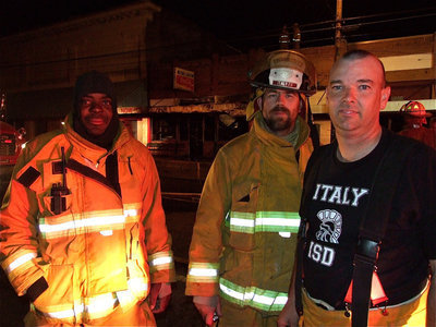 Image: Long night — Italy’s volunteer firefighters, Lynn Lambert, Russell Coers and Paul Cockerham get ready to pack up the equipment.