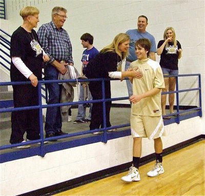 Image: Proud family — Cole Hopkins gets congratulated by his family. The youngster put in 6-points against Hearne but made his biggest impact on the defensive boards.