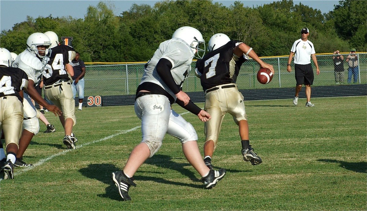 Image: Tyler pressures Q.B. — Italy’s Tyler Vencill forces Hubbard’s quarterback to run for cover.