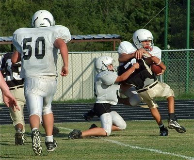 Image: Caden and Chace — Caden Petrey(35) and Chace McGinnis(84) wrap up a Jaguar for a big loss on the play.