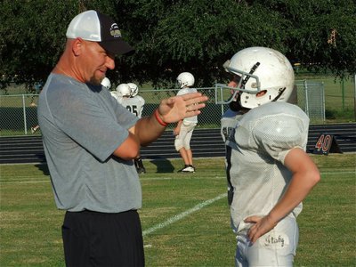 Image: Coach teaches — Defensive coach Jeff Richters talks shop with linebacker John Escamilla.