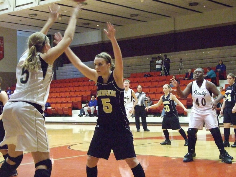 Image: DeMoss Feeds The Post — Passing the ball into the post is a bit of an art and DeMoss paints another masterpiece while brushing off a Dawson defender.