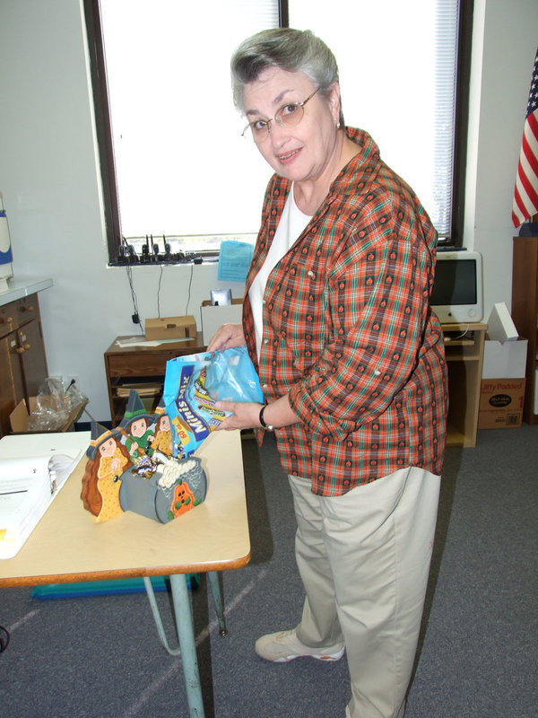 Image: Marilee Byrne  — Marilee Bryne, Milford ISD principal, filling the witches pot.