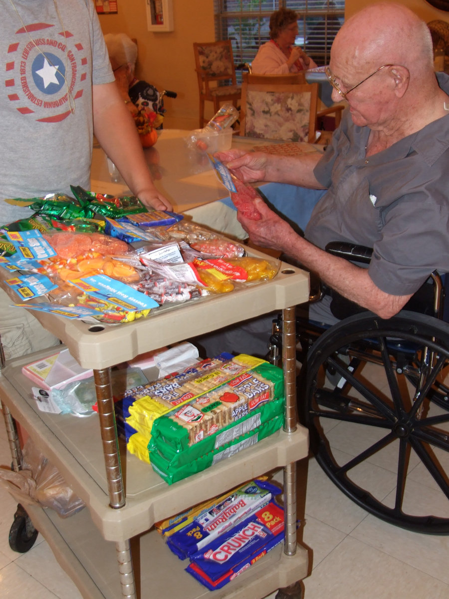 Image: Look at the prizes — Mr. Kelly got Bingo and is having a hard time choosing his prize.