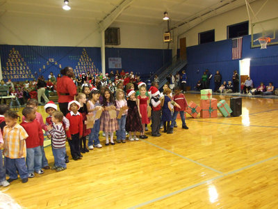 Image: Cute Performers — These students are ready to rock with their Christmas music.