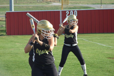 Image: The lineup — Alyssa Richards, Anna Viers and Megan Richards get prepared to swat some softballs.